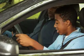 father teaching his son to drive