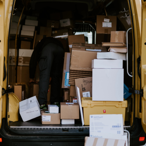Man loading van with cardboard boxes
