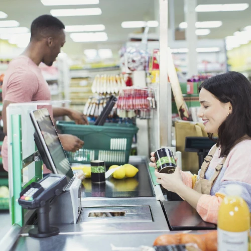 Cashier scanning items in convenience store