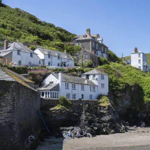 Homes on cliff hillside next to a beach