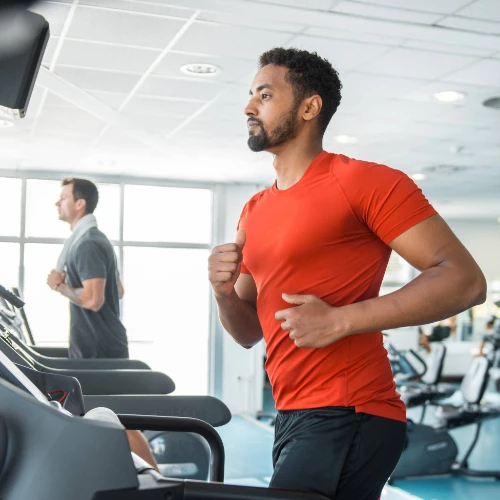 Two men running on treadmills