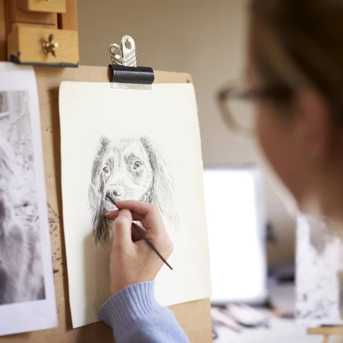 Woman sketching dog on paper