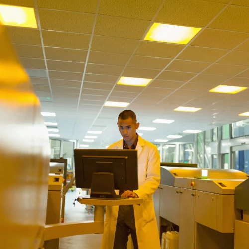 Man working at industrial printer computer