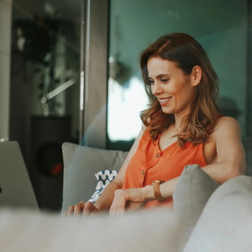 woman smiling down at laptop