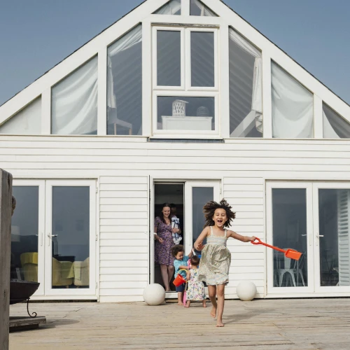 children running and playing on the decking of their second home