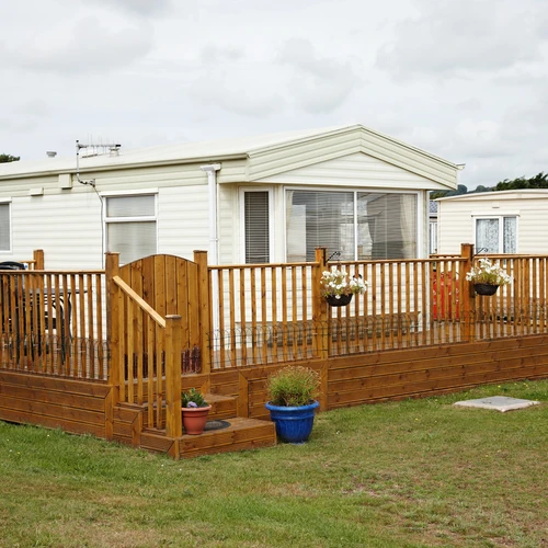 a static caravan surrounded by a wooden decking