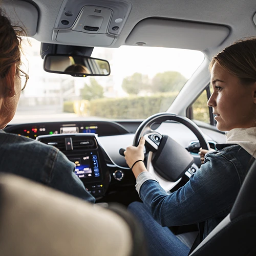 a learner driver driving with the supervision of a driving instructor