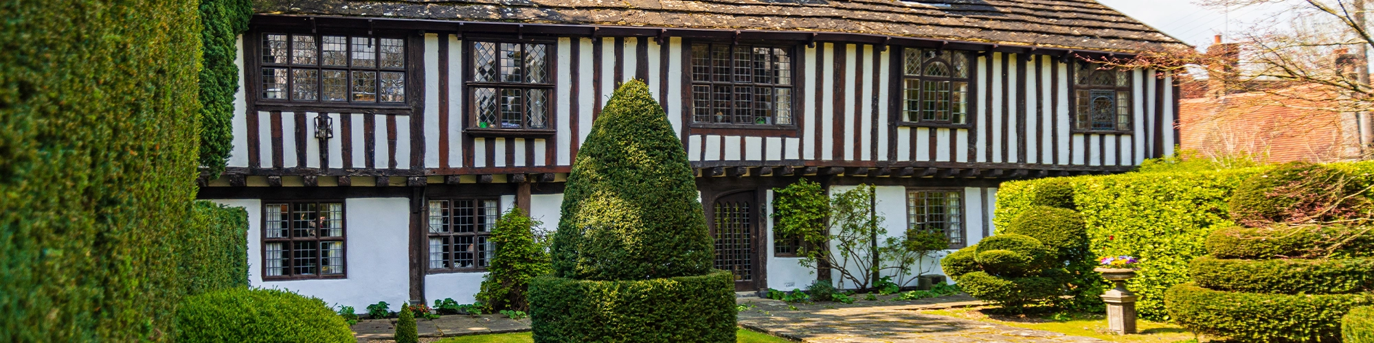 front of a high value home with a garden